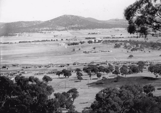 Canberra, the bush capital, in 1927, around the time Parliament House was opened. The white building in the centre is West Block, the other white building behind the trees is Parliament House. (National Library of Australia)