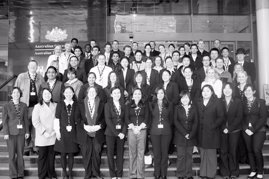 A group of tax officers gathers to celebrate the tenth anniversary of the graduate program.