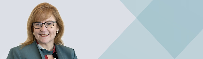Photo of Janine Bristow with blue background